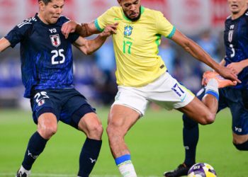Brazil's midfielder Joelinton (C) shoots the ball during the international football friendly match between Japan and Brazil at the Tokyo stadium in Chofu, Tokyo prefecture on October 14, 2025. (Photo by Yuichi YAMAZAKI / AFP)